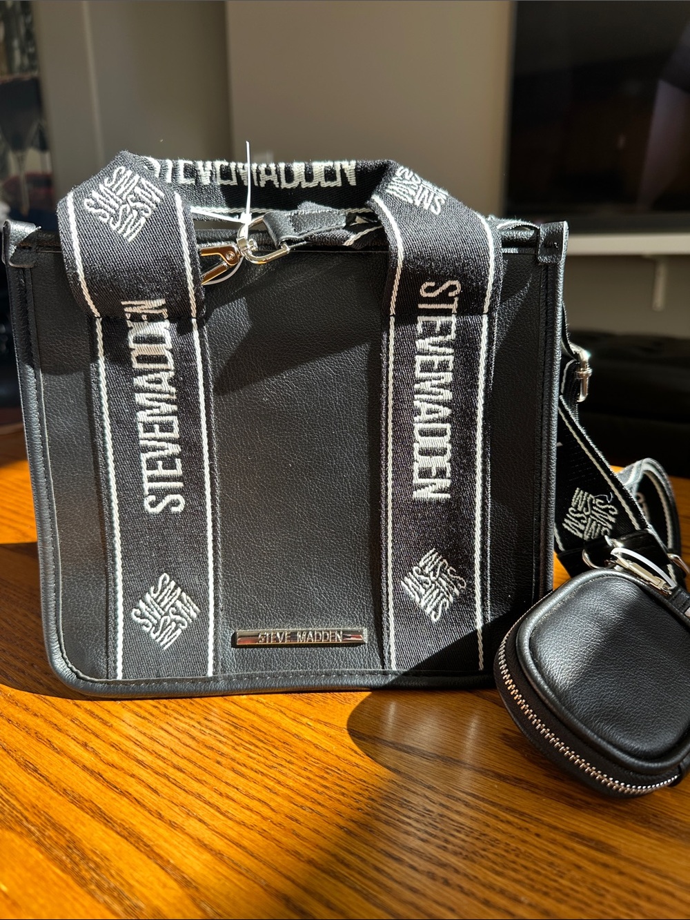Steve Madden Bwebber tote with Branded Webbing and snap closure.